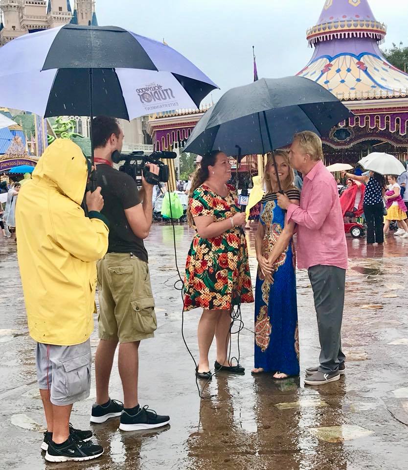 Shelley Caran interviewing Pat Sajak and Vanna White in the Magic Kingdom at the Walt Disney World Resort