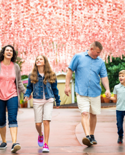 Families walking under the Showstreet I Will Always Love You Festival Art Installation