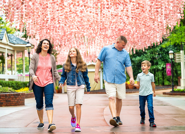 Families walking under the Showstreet I Will Always Love You Festival Art Installation
