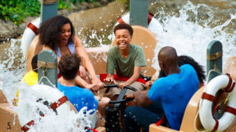 Smoky River Mountain Rampage Dollywood attraction with a family raft crashing through whitewater rapid